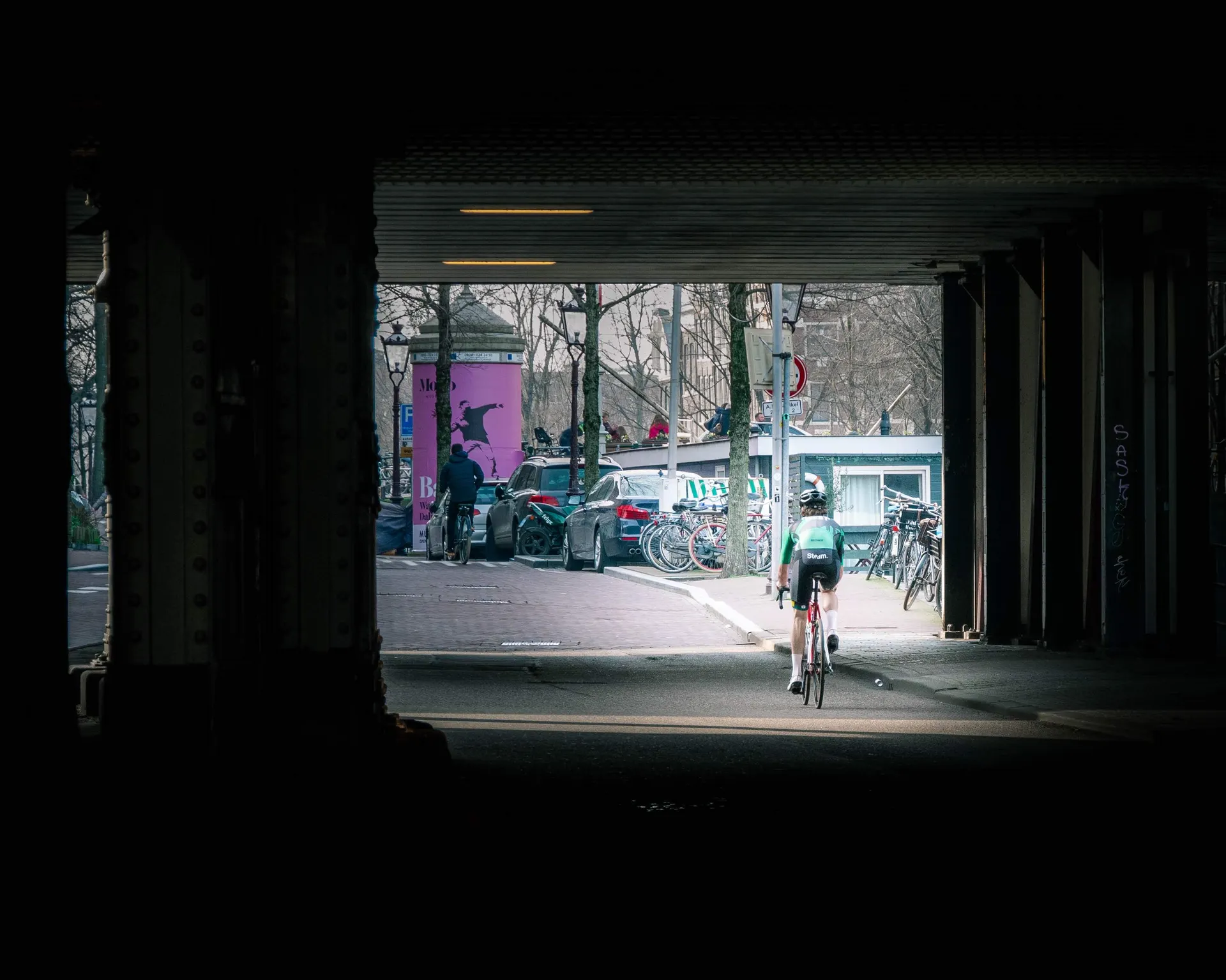image of a cyclist exiting a tunnel
