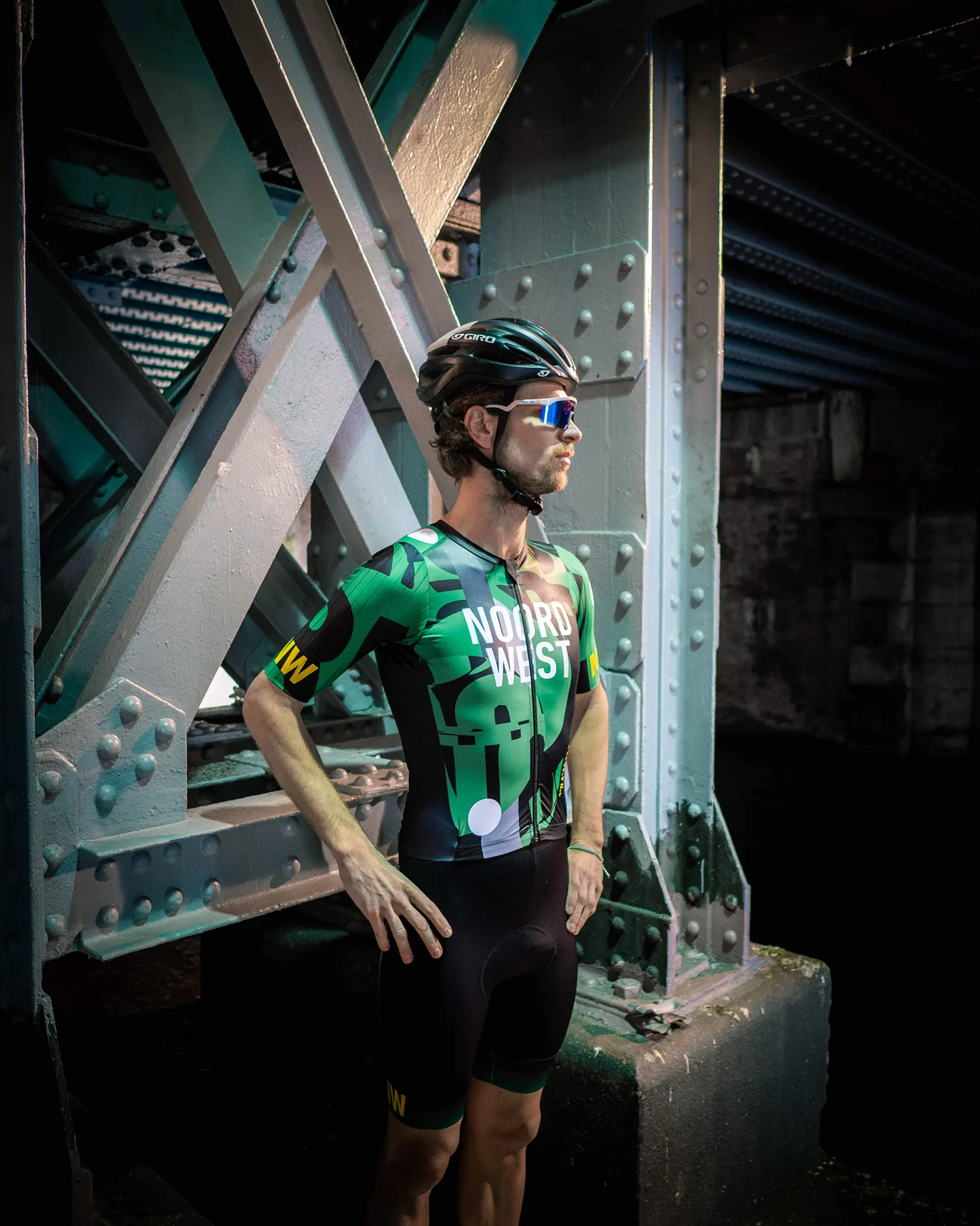 image of the final cycling jersey, worn by a cyclist under a bridge in bright light